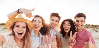Group of happy young friends in summer clothes