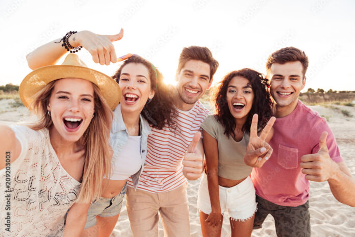 Group of happy young friends in summer clothes