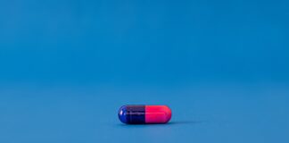 red and blue pill on blue surface