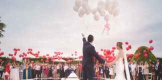 photo of a man and woman newly wedding holding a balloons
