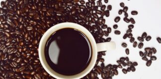 coffee cup with coffee beans close-up photography