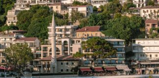 white and brown concrete building near body of water during daytime