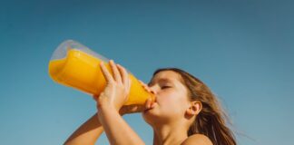 girl drinking yellow juice