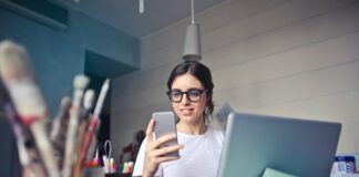 woman in white shirt using smartphone