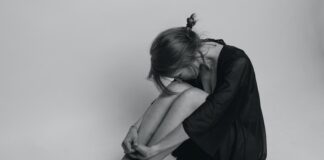 woman in black dress sitting on floor