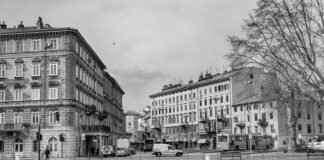 grayscale photo of buildings and boats