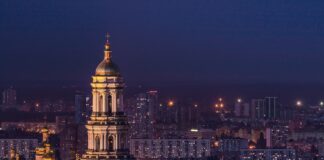 white and green tower during night time