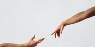 persons hand on white wall