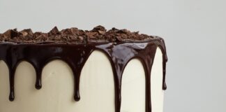 white cake with chocolate syrup on white ceramic plate