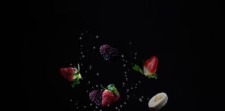 clear glass jar with red and green fruits