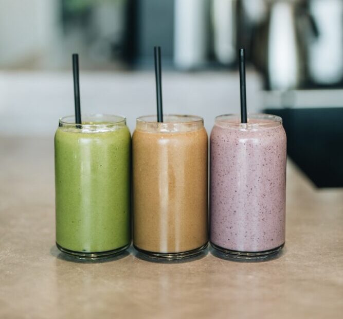 three drinks on gray surface