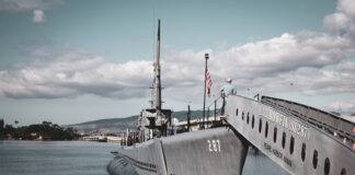 grey warship on dock during daytime