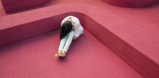 woman sitting leaning forehead on knee