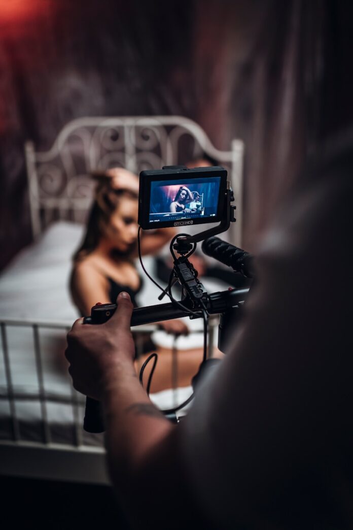 person holding black corded headphones