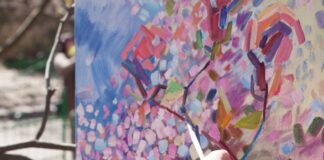 person holding green and blue pencil