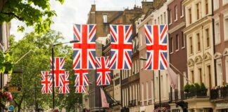 a british flag hanging over a city street