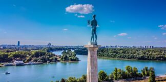 a statue of a man standing on top of a tower