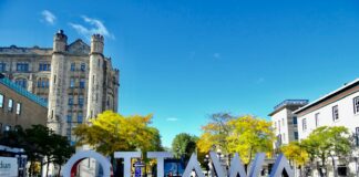 white and red concrete building near green trees during daytime