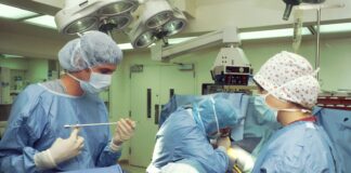 people in blue scrub suit sitting on chair