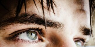 close up photo of gray-eyed man