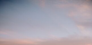 the wing of an airplane flying over a city
