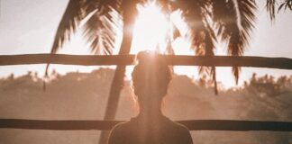 woman doing yoga meditation on brown parquet flooring