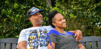 man in white crew neck t-shirt sitting beside woman in black and white stripe shirt