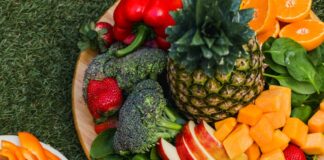 sliced orange fruits on brown wooden tray