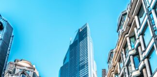 people walking on street between high rise buildings during daytime