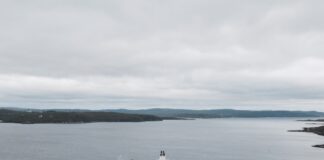 black and brown ships under cloudy sky