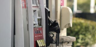 a gas pump next to a brick wall