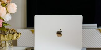 a white apple laptop sitting on top of a table