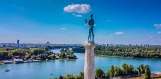 a statue of a man standing on top of a tower