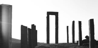 a black and white photo of a grassy hill