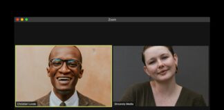 man in black suit jacket smiling