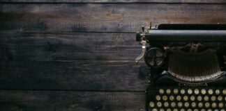 black Corona typewriter on brown wood planks