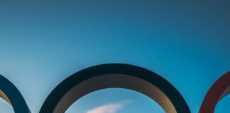 the olympic rings in front of the eiffel tower