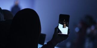 person using phone doing video of woman