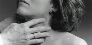 a woman has her hand on the shoulder of a man