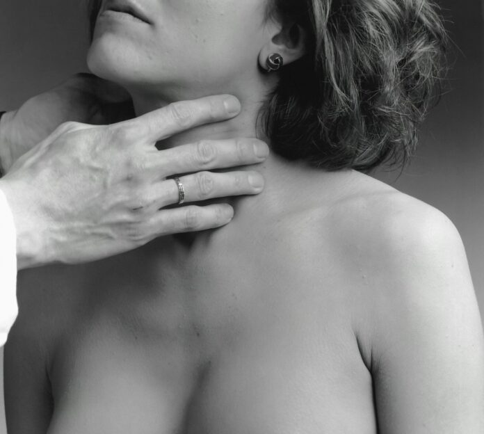 a woman has her hand on the shoulder of a man