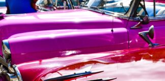 a row of classic cars parked next to each other