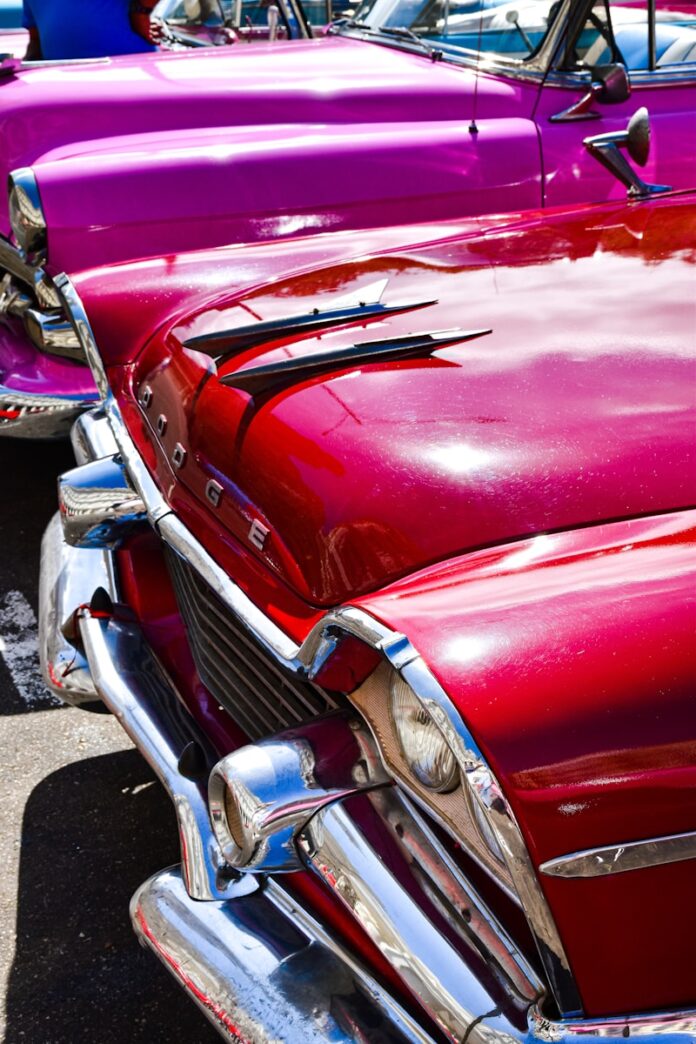 a row of classic cars parked next to each other
