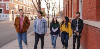 three men and laughing two women walking side by side