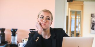 woman in black long sleeve shirt using macbook