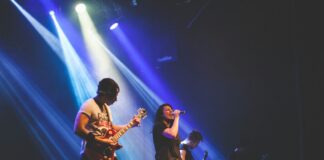 photo of male band performing on stadium