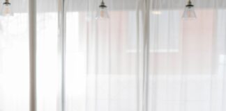 man in blue and white plaid dress shirt sitting on chair using laptop computer