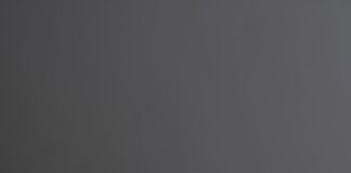 person wearing gold ring holding black textile