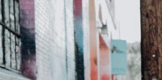 man in black leather jacket beside woman in black and white stripe shirt