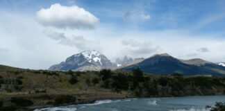 a waterfall with a mountain in the background