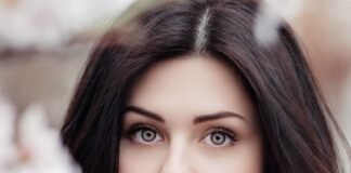 woman standing near white petaled flower